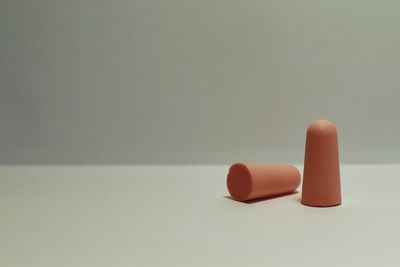 Close-up of colored pencils on table against white background