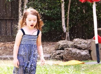 Portrait of smiling girl playing in water