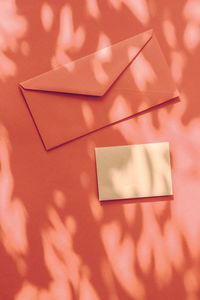 High angle view of envelopes on orange background