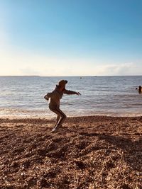 Man on beach against sky