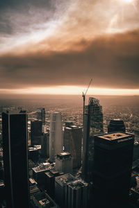 Cityscape against cloudy sky