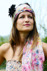 Beautiful woman wearing scarf looking away