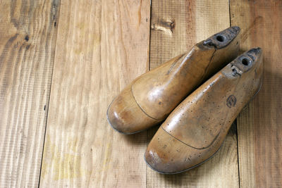 High angle view of old shoes on wooden table