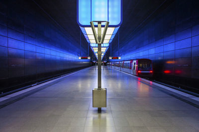 Train at illuminated subway station