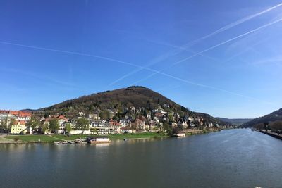 Scenic view of residential buildings in town against sky