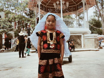 Portrait of smiling girl standing outdoors