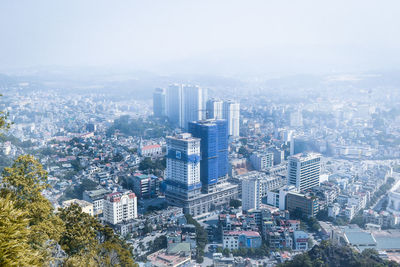 High angle view of buildings in city against sky