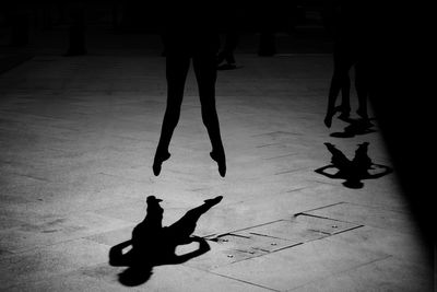 Low section of woman standing on tiled floor