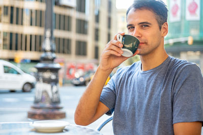 Portrait of man drinking coffee in car