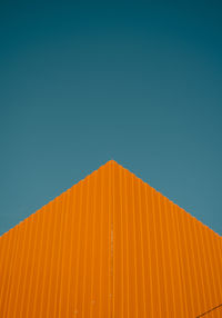 Low angle view of building against clear blue sky