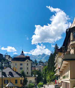 Buildings in town against blue sky