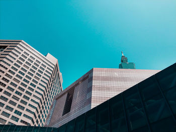 Low angle view of skyscraper against clear blue sky