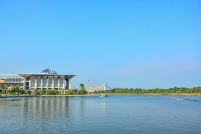 View of bridge over river against blue sky