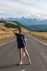 Full length of man skateboarding on road against sky