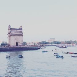 Boats in river with buildings in background