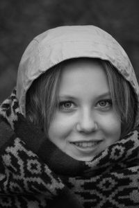 Close-up portrait of smiling young woman wearing hood