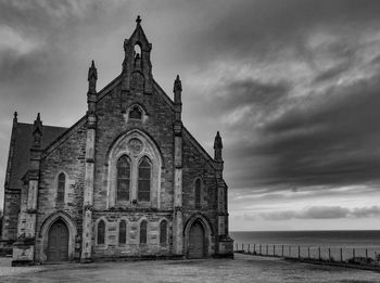 Historic building by sea against sky