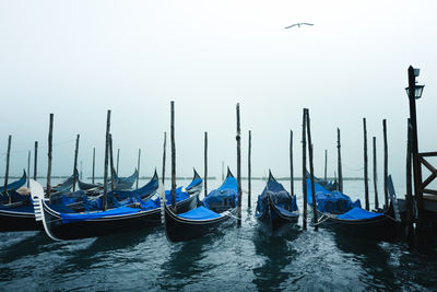 Boats moored in canal against clear sky in venice