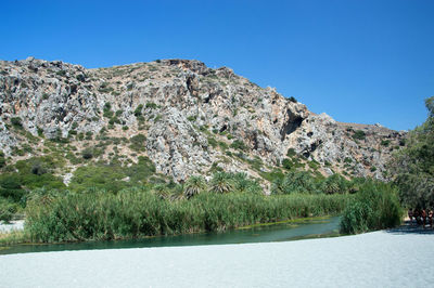 Scenic view of mountains against clear blue sky