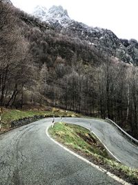 Road by mountain against sky