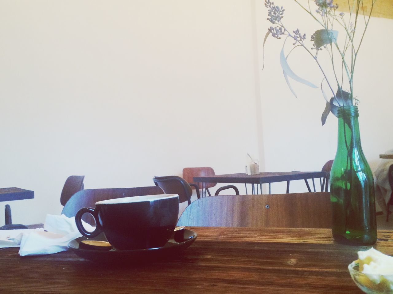 indoors, table, still life, home interior, drink, vase, food and drink, glass - material, bottle, drinking glass, refreshment, wood - material, jar, chair, close-up, no people, container, absence, empty, wall - building feature