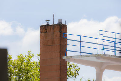 Low angle view of factory against sky