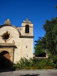 Low angle view of building against clear blue sky