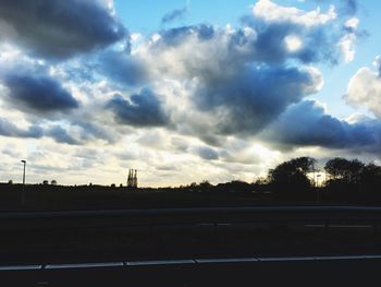 Silhouette of trees against dramatic sky