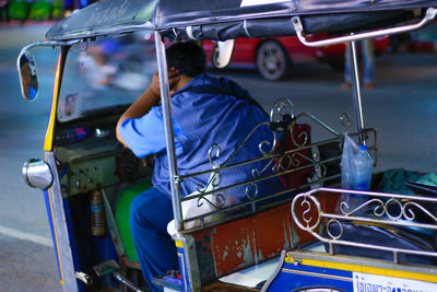 Rear view of man sitting in taxi