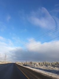 Country road against sky