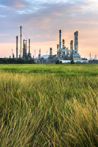 View of factory against sky at sunset