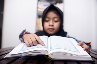 Mid adult woman reading book