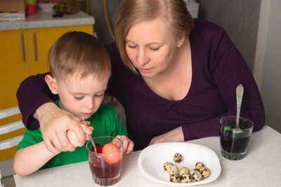 Portrait of boy eating food at home