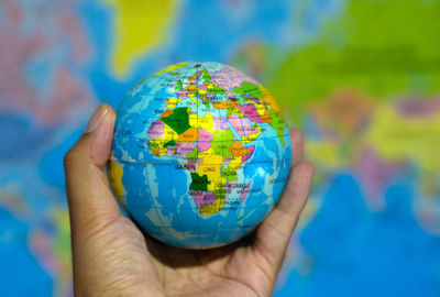 Cropped hand holding globe
