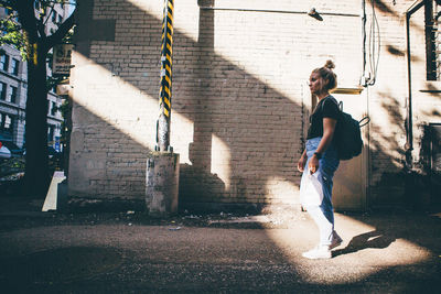 Woman with umbrella walking in city