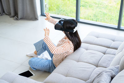 Woman gesturing by wearing virtual reality simulator