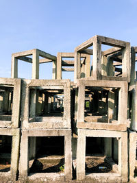 Low angle view of abandoned built structure against blue sky