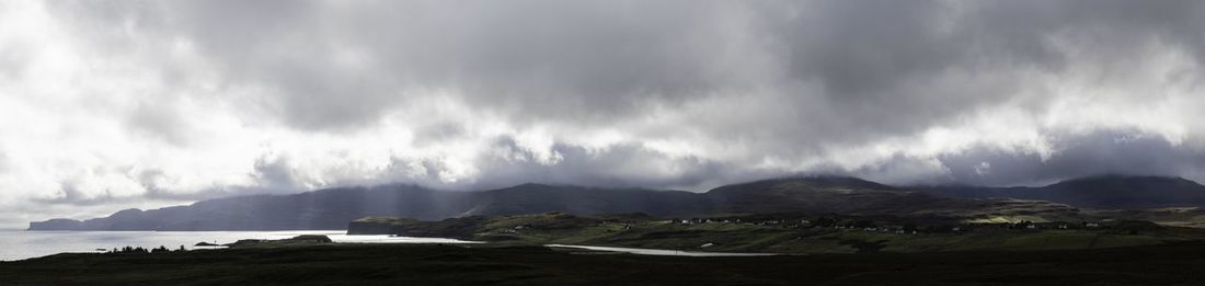 Panoramic view of mountains against cloudy sky