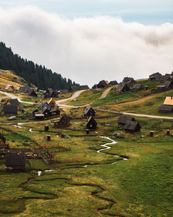 Scenic view of village  field against sky