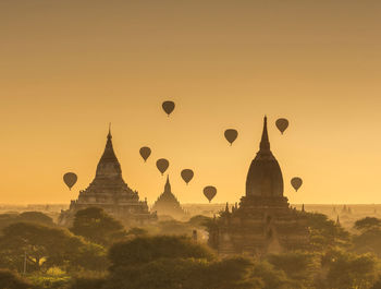 Temples against clear sky at sunset