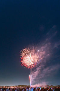 Low angle view of firework display at night