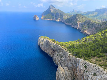 High angle view of rocks by sea against sky