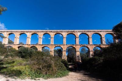 Arch bridge against blue sky