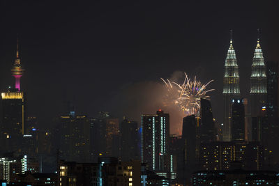 Low angle view of firework display at night