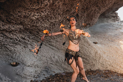 Portrait of dancer dancing against rock formation