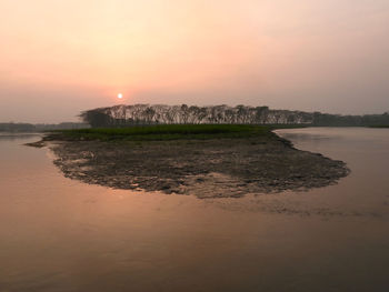 Scenic view of river against sky during sunset