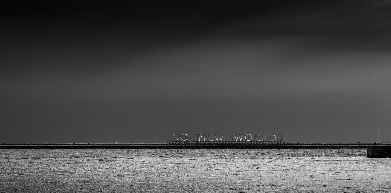 SEA BY PIER AGAINST SKY