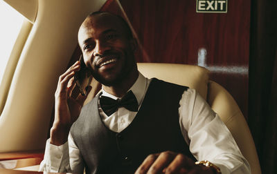 Portrait of young man sitting at home