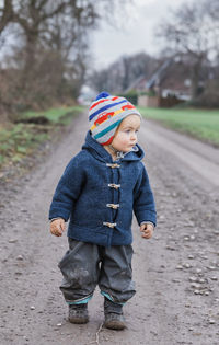 Cute girl walking on footpath