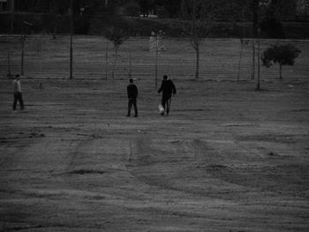 Silhouette men standing on soccer field